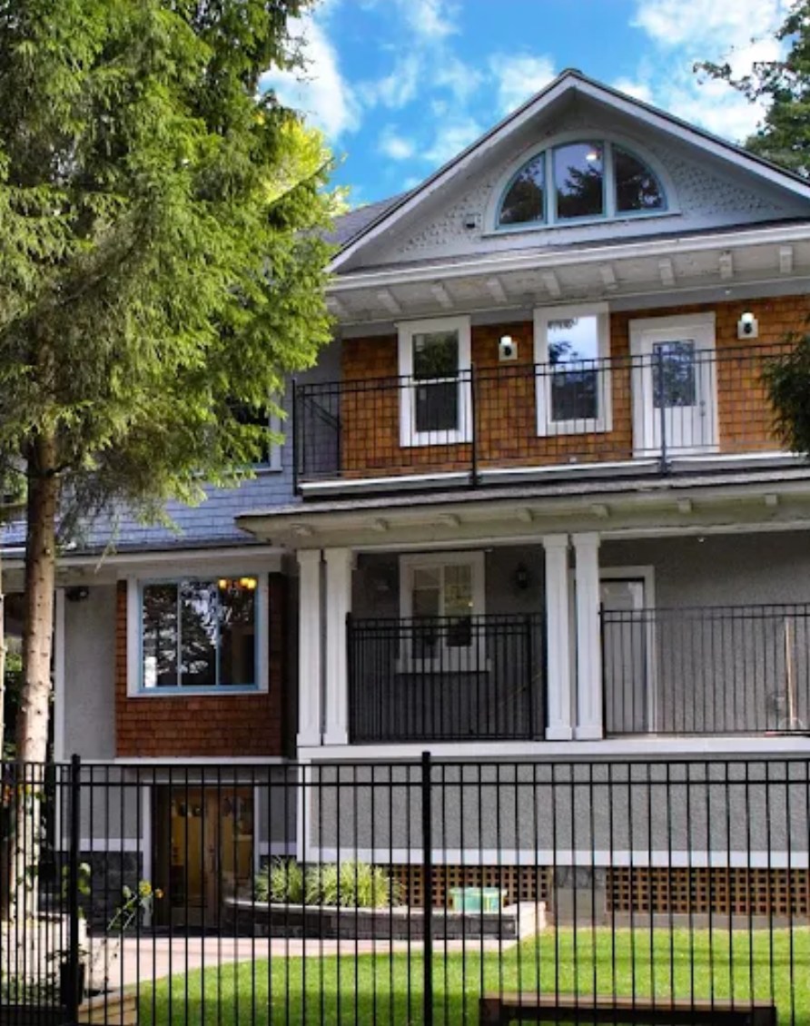 The Granville House Montessori School building on Granville Street, a heritage home with an arched gable window, wraparound balconies, and a fenced front garden